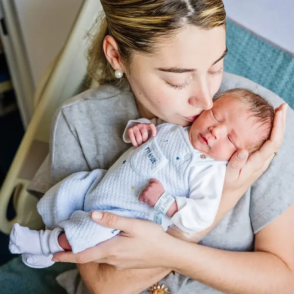 Maman qui fait un bisous à son nouveau né PHOTOGRAPHE BÉBÉ À LA MATERNITÉ JULES VERNE DE NANTES